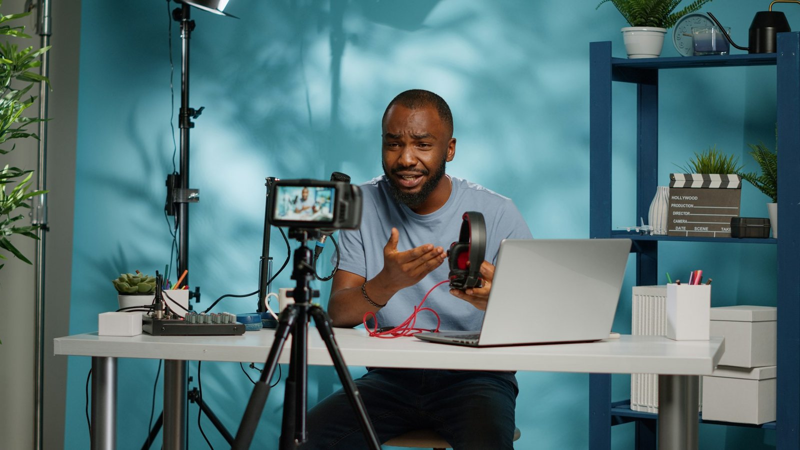 Content creator holding headphones for product review